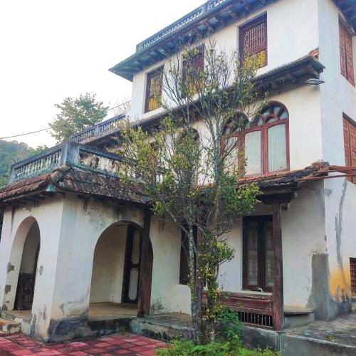 an old house with a tree in front of it at Balthali Heritage Inn Resort in Panaoti