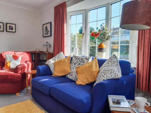 a living room with a blue couch with pillows on it at Peel Wyke in Keswick