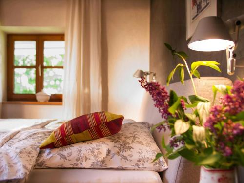 a bedroom with a bed and a vase of flowers at Alpine Chalet Apartment With Zugspitze Views in Grainau