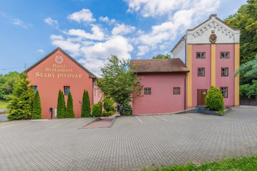 a building with a sign on the side of it at Hotel STARÝ PIVOVAR in Prague