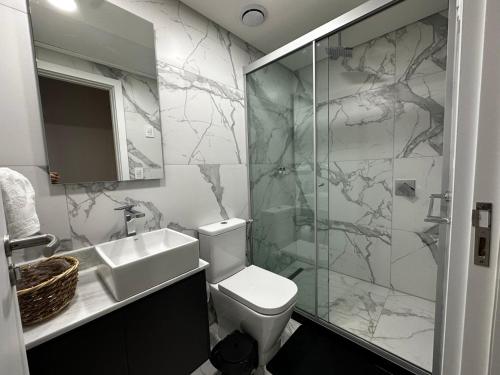 a bathroom with a toilet and a sink and a shower at Luxury 2 Bedroom "Wake Up in the Sky" Best Views & Location in Asuncion in Asuncion