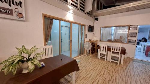 a room with a table and chairs and a dining room at Baan Puen Poonsuk in Hua Hin