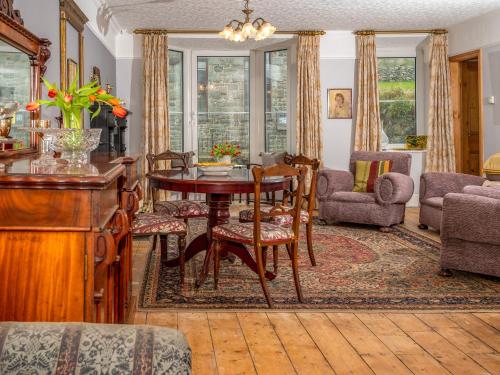 een woonkamer met een tafel en stoelen bij Galeri Harlech Townhouse in Harlech