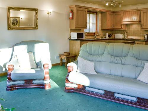 two chairs and a couch in a living room at The Wheelhouse in Linlithgow
