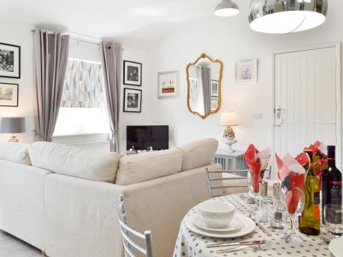 a living room with a couch and a table at The Duck House in Ruckinge