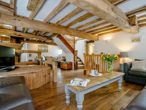 a living room with a table and a couch at The Water Mill in Bradbourne
