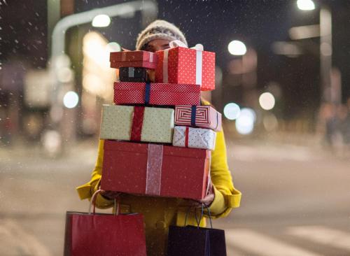 a woman is holding a stack of presents on a fire hydrant at Country Inn & Suites by Radisson, Hagerstown, MD in Hagerstown