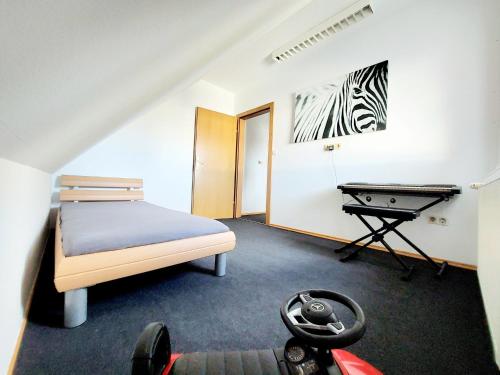 a bedroom with a bed and a table in it at Guesthouse Graz Central for 9 People in Graz