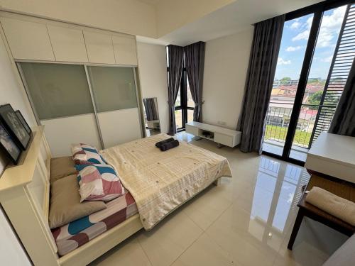 a bedroom with a bed and a large window at Spacious 3BR Homestay - Trinity Residence Kuching City in Kuching