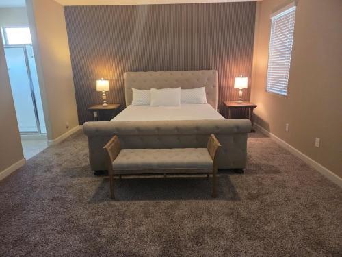 a bedroom with a bed and a couch and two lamps at Comfortable Family Getaway in Buckeye in Buckeye