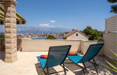 two chairs on a patio with a view of a city at Nice Apartment In Selca With Kitchen in Selca