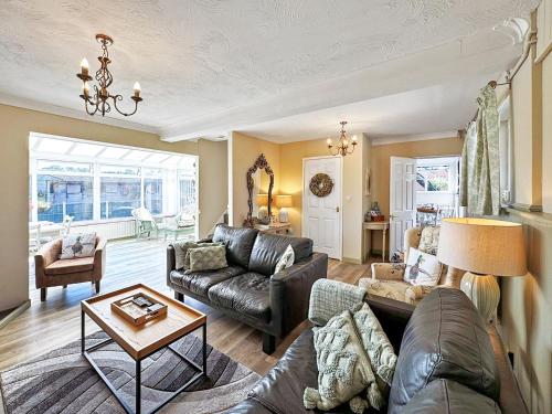 a living room with a couch and a table at Broadoak Barn in Ellesmere