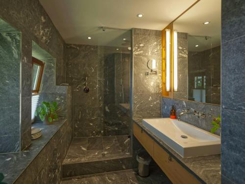a bathroom with a sink and a shower at Alpine Chalet Apartment With Zugspitze Views in Grainau