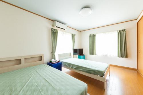 Ένα ή περισσότερα κρεβάτια σε δωμάτιο στο 民泊大森別邸, 一棟貸切3 bedrooms, Shimonada Station, Futami Seaside Park, 200 steps to the sea