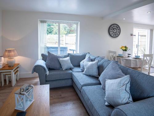 a living room with a blue couch and a table at The Shambles in Fulletby