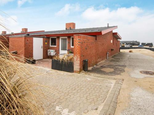 a brick house with a driveway in front of it at 5 person holiday home in Henne-By Traum in Henne Strand