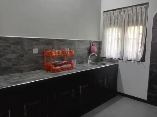 a kitchen with a sink and a counter top at The Onisula Guest House in Ahangama