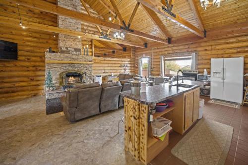 a kitchen and living room with a fireplace at Ponderosa Inn in Escalante