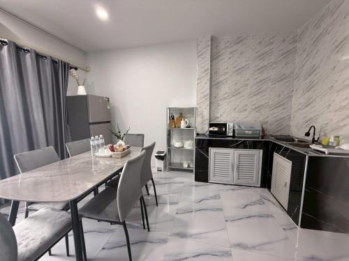 a kitchen and dining room with a table and chairs at Together Stay Home in Mae Sai