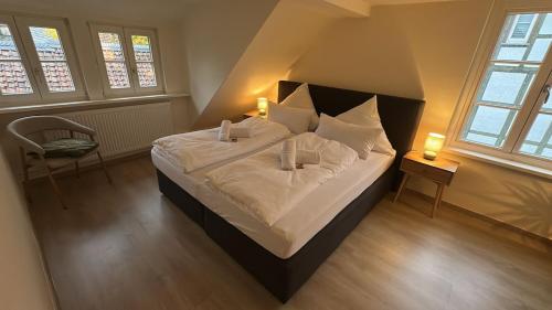 a bedroom with a large bed with white sheets and pillows at Wohlfühloase Goslar no 3 in Goslar