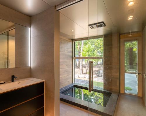 a bathroom with a sink and a large window at Base 47 Hakuba by Jade Group in Hakuba