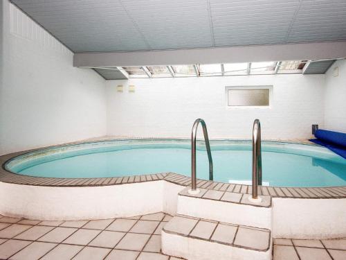 a large swimming pool in a building with a pool at 8 person holiday home in Ørsted-By Traum in Kare