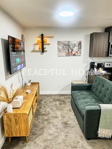 a living room with a couch and a table at Peaceful Homes - Elegant 2 Bedroom Suite in Calgary
