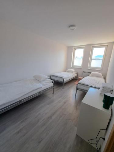 a room with two beds and a table at Budget Apartment KNM5 in Kysucké Nové Mesto