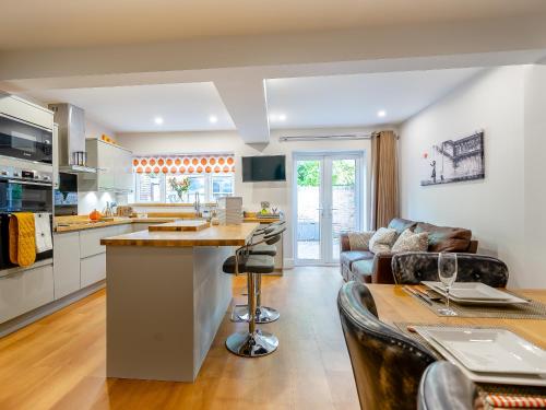 a kitchen and living room with a couch and a table at Hare Bee & Bee in Stratford-upon-Avon