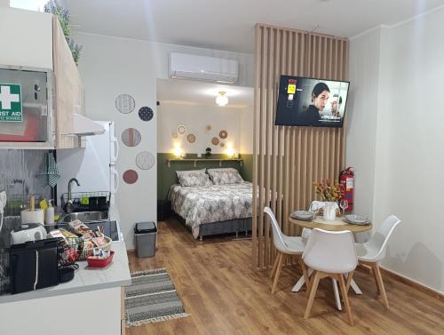 a small room with a bed and a table and chairs at Studio35 in Athens