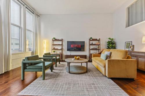 a living room with a couch and two chairs at 2BR Downtown Gem with Arcade games! - Sleeps 7 - Near Convention Center - Stadium in Indianapolis