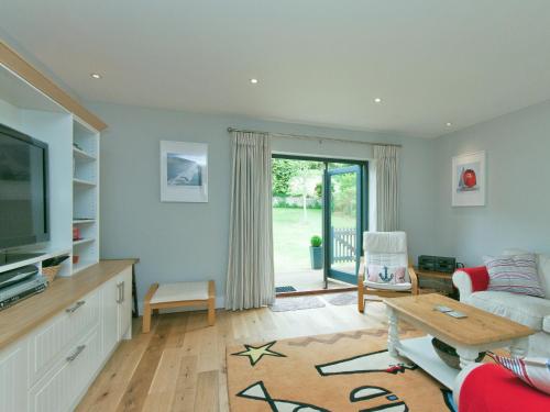 a living room with a couch and a table at Eddystone Row 2 in Salcombe