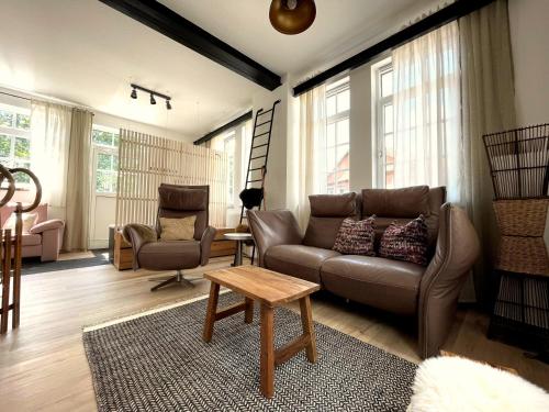 a living room with a couch and a table at Thüringer Wald-Zauber in Zella-Mehlis