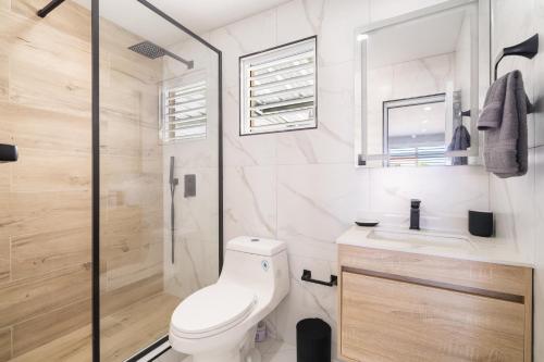 a bathroom with a toilet and a shower and a sink at 2bedroom Lux house Isla Verde with Private Patio by PH in Carolina