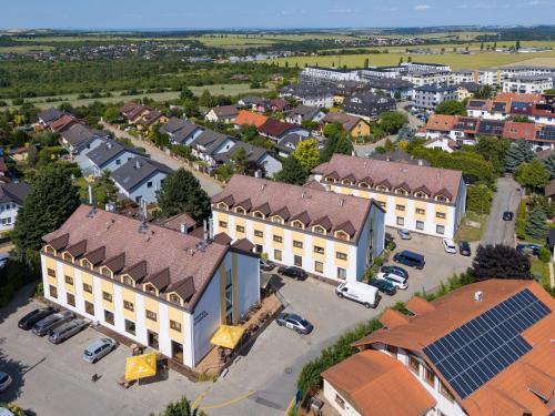 an overhead view of a building with a parking lot at Hotel CHOTOL in Horoměřice