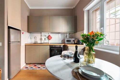 a kitchen with a table with a vase of flowers at Casa KAI Ostia in Lido di Ostia