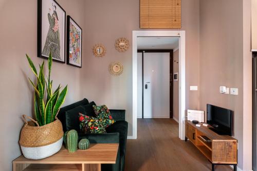 a living room with a black couch and a table at Casa KAI Ostia in Lido di Ostia