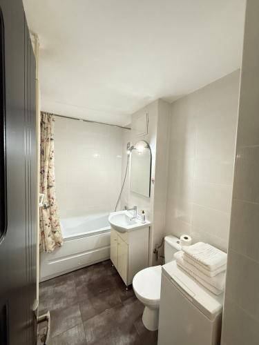 a white bathroom with a sink and a toilet at Apartament Densia in Craiova close to the center in Craiova