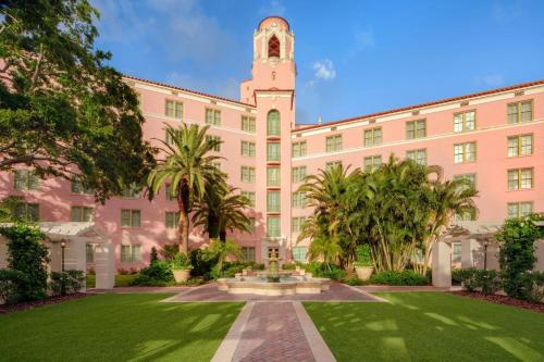 a large pink building with a clock tower at The Vinoy Resort & Golf Club, Autograph Collection in St. Petersburg