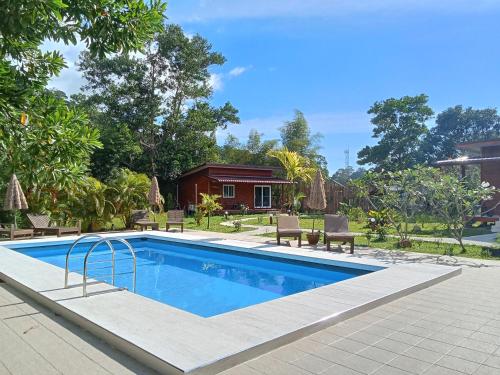 a swimming pool in front of a house at Jungle View Resort in Ko Chang