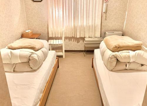 Postel nebo postele na pokoji v ubytování たんばら高原 ペンション スターガーデン