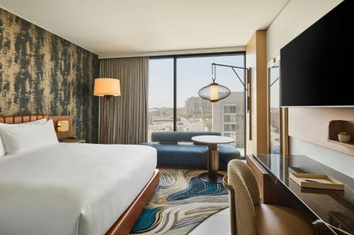 a hotel room with a bed and a desk at The REMI Scottsdale, Autograph Collection in Scottsdale