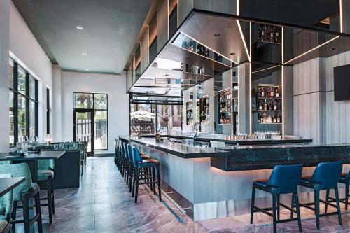 a bar in a restaurant with chairs and tables at AC Hotel Las Vegas Symphony Park in Las Vegas