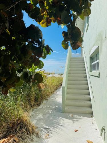 a stairway leading up to a building with a stair case at North Shore Duplex #54588 Duplex in Anna Maria