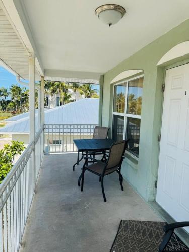 a patio with a table and chairs on a porch at North Shore Duplex #54588 Duplex in Anna Maria