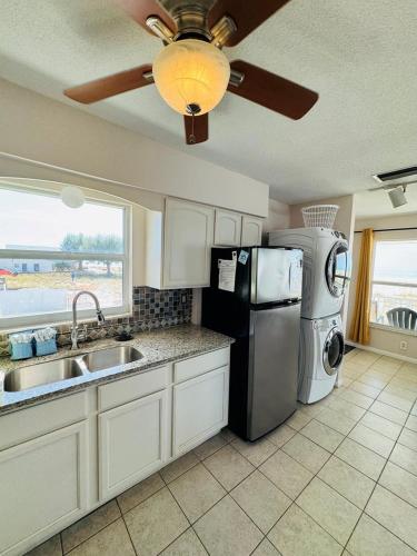 a kitchen with a refrigerator and a sink and a ceiling fan at North Shore Duplex #54588 Duplex in Anna Maria