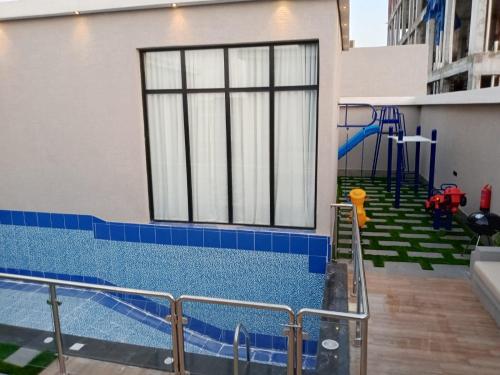 a swimming pool with a playground in a building at شاليهات أجواء الريف in Dammam