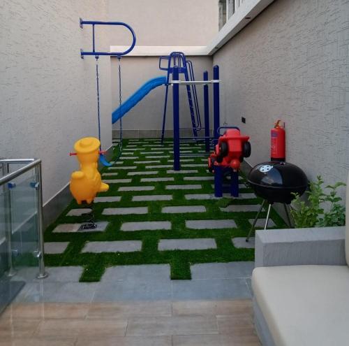 a room with a play area with a green floor at شاليهات أجواء الريف in Dammam