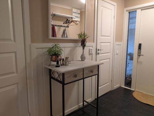 a hallway with a console table with plants on it at Home in Vingåker in Vingåker