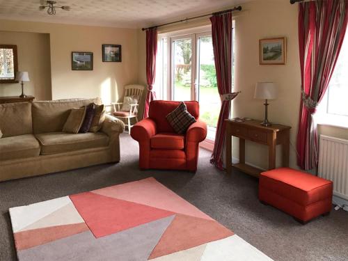 a living room with a couch and a chair at Kestral in Welney